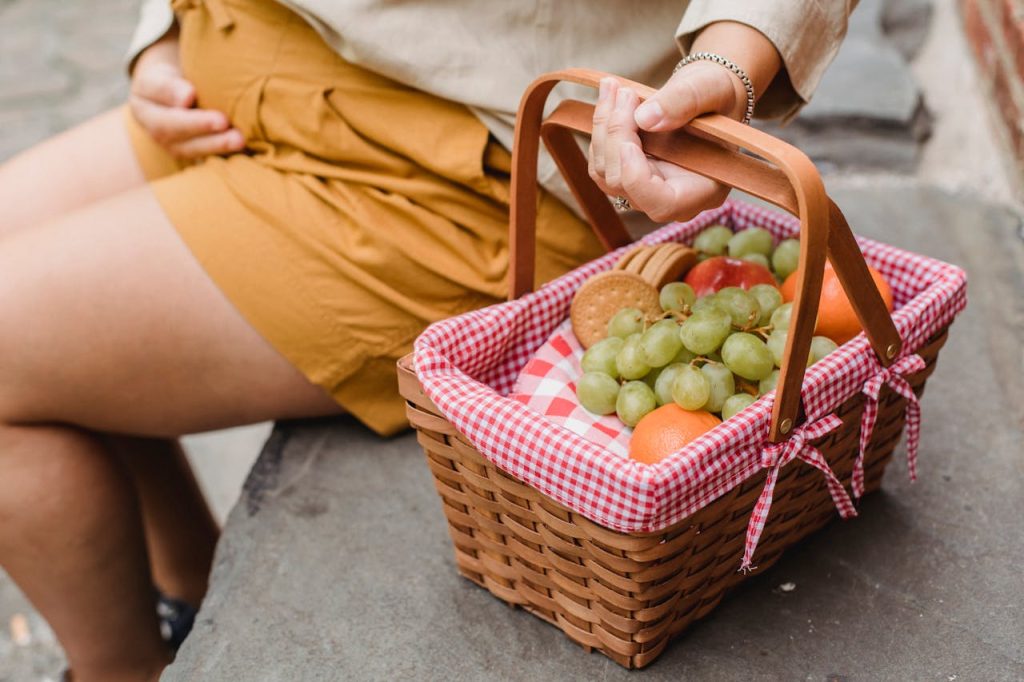 crop-pregnant-woman-with-basket-of-fruits-5425104 Crop anonymous pregnant female in casual outfit with basket full of fresh ripe fruits and tasty cookies prepared for picnic